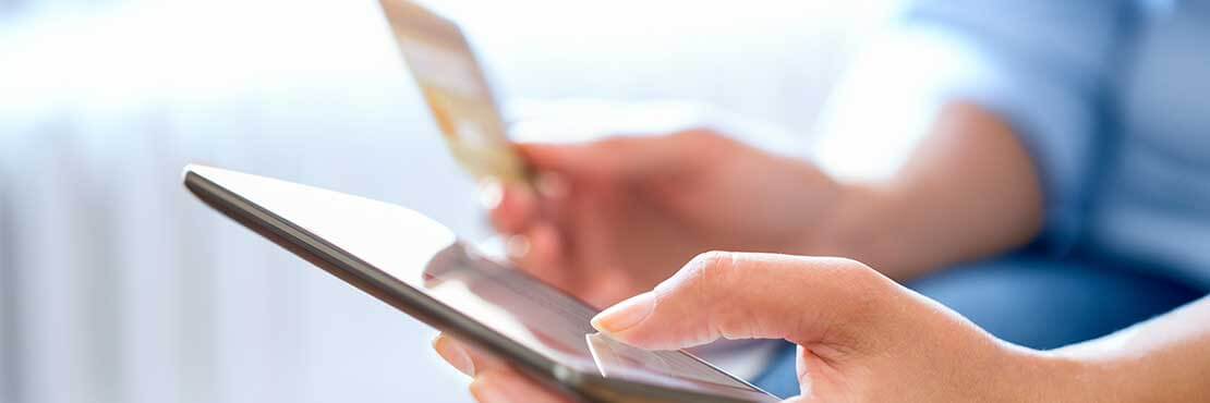 Man holding a mobile phone and a credit card