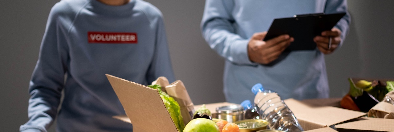 Photo of two volunteers in food bank, packaging food